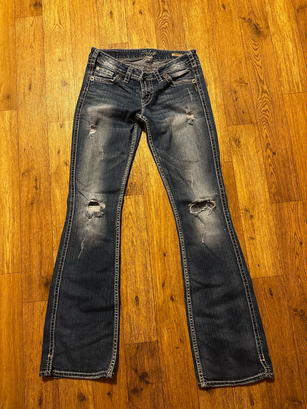 Silver Jeans with distress.